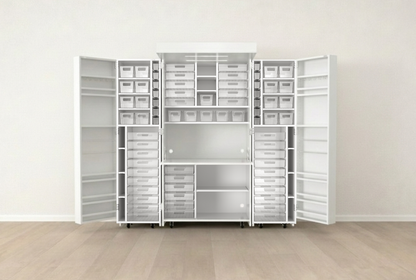 White storage system with shelves and drawers in a room with wooden flooring and white walls.