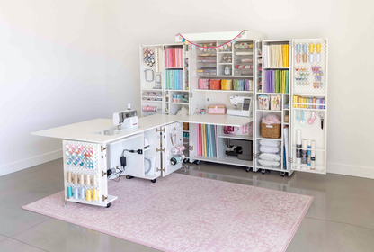 Craft room with sewing table and shelves filled with supplies [Deluxe]