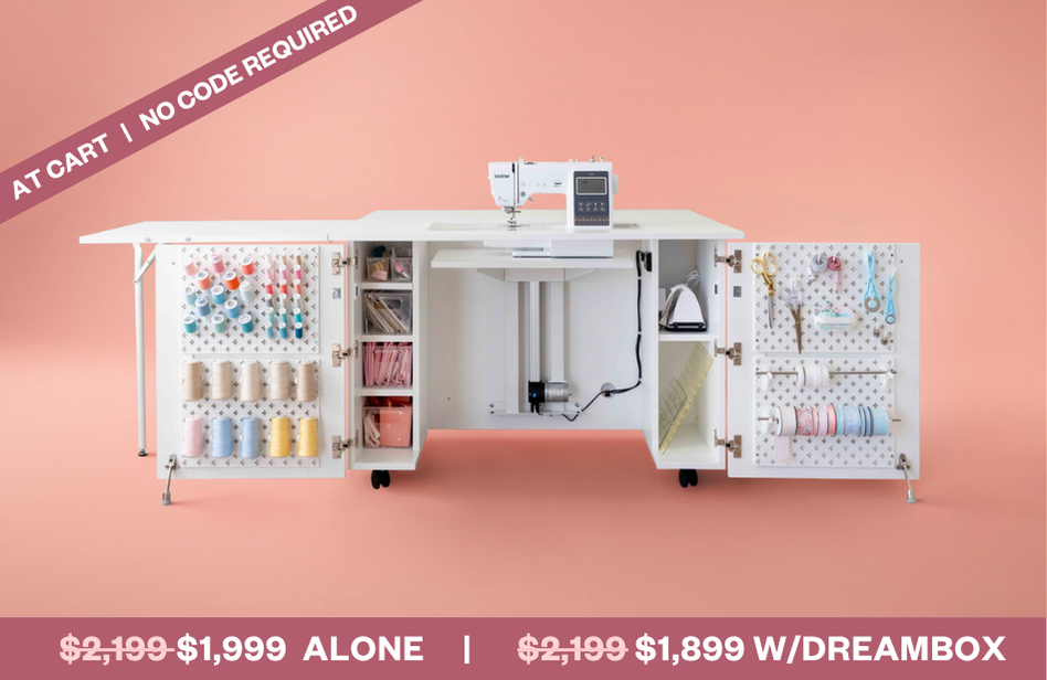 Sewing machine with open cabinets displaying thread and accessories on a pink background [Deluxe]
