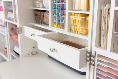 A close-up of built-in drawers with brushed nickel finishes installed in a DreamBox.